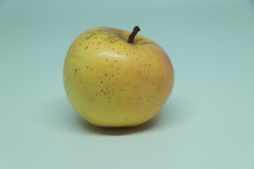 One yellow Apple close-up on a white. Isolated, golden delicious apples isolated