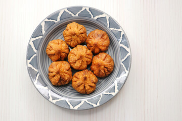Fried Modak. It's a traditional sweet dish of coconut, jaggery, and dry fruits stuffed inside the wheat dough. Offered to Lord Ganesha during the Ganpati Chaturthi festival in India. with copy space. 
