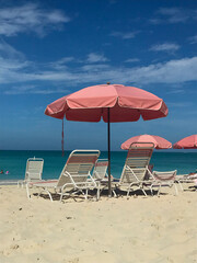 beach chairs and umbrella in grace bay turks and caicos