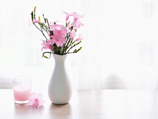 Pink flowers in vase on table Ruellia tuberosa flowering plant ,minnieroot ,fever root ,snapdragon...