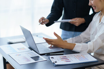 Fototapeta premium Close-up of a group of business people working together to plan a marketing strategy using a laptop to analyze the balance sheet report, quarterly financial statement.