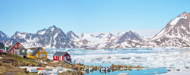 Fotobehang Panoramic view of colorful Kulusuk village in East Greenland - Kulusuk, Greenland - Melting of a iceberg and pouring water into the sea © muratart