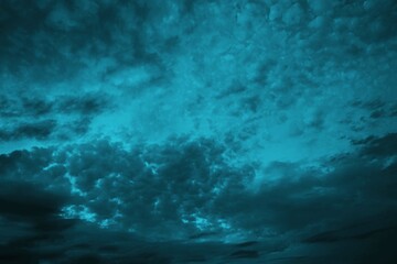 Black blue green night sky with clouds. Wind. Before the storm. Dramatic skies. Dark teal color background for design. Abstract. Toned cloudy gloomy sky. Dusk.