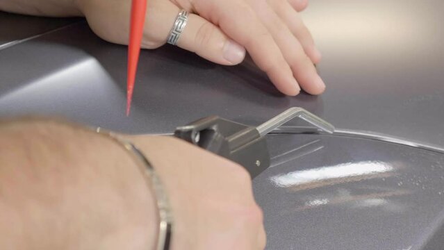 Heat Gun Used To Help Stick Adhesive Film During Car Wrapping Process.