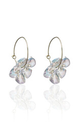 Close-up shot of hoop earrings with pearlescent flower. The french clip resin flower earrings are...