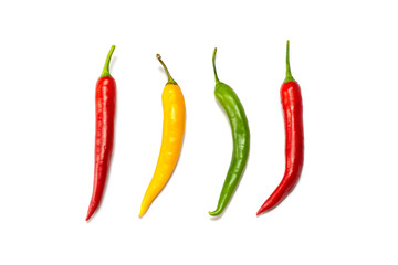 four hot peppers, red, green and yellow,  on a white background