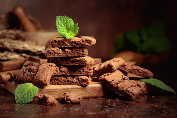 Brownie with mint on an old table with kitchen utensils.