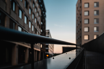 Metal rail with buildings in the background