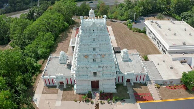 Aerial drone rotating shot over a traditional south Indian hindu temple in Greater Chicago, USA on a sunny day.