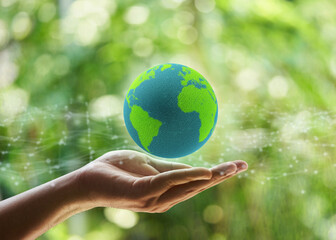 hand holding global icon ESG concept. Environment, society and governance business on green background.                                                