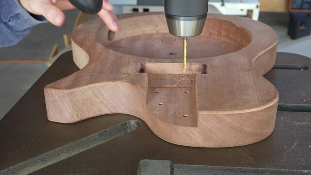 Guitar Builder Man Drilling Holes in Guitar's Body for Mounting P90 Pickup with Drill Press