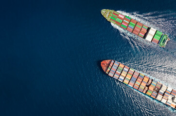 High aerial top down view of two container cargo ships traveling over open ocean with copy space as a concept for import and export industry - 527517457