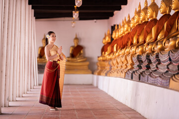 Portrait happy Asian model posing to pay respect with smiling wearing Thai dress traditional...