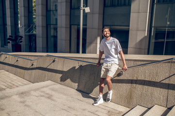 Young guy in light clothes outside in the business area