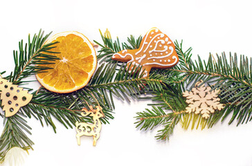 natural fir tree pine cone green grass in middle with some decoration.gingerbread angel cookie,wooden eco toys snowflake deer shape,dry orange slice.christmas background,winter