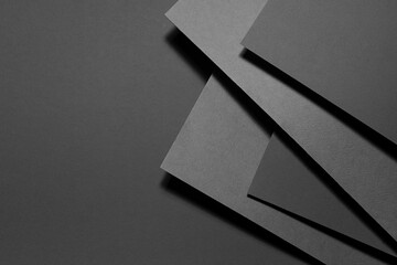 Carbon grey abstract geometric background with fly rectangle stepped surfaces with corners in hard light, shadows in rich minimal business style for card, poster, flyer, text, top view, copy space. - obrazy, fototapety, plakaty