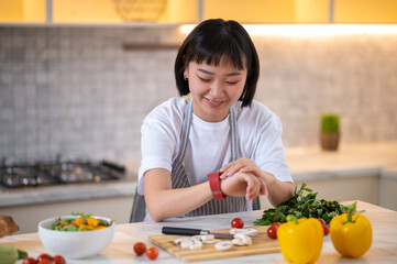 A girl in the kitchen preparing to cook something tasty