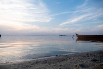 Boat on the shore of the lake. Beach by the lake