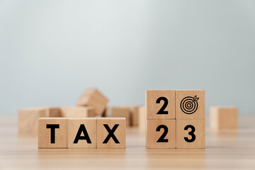 2023 tax concept, paying taxes, 2023, paying tax rates, collecting taxes, tax burden icon on wooden...
