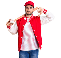Young handsome man holding baseball bat and ball with angry face, negative sign showing dislike...