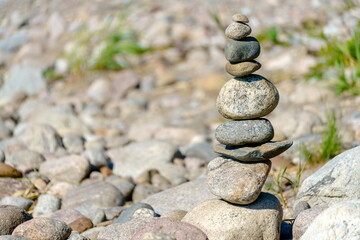 Pyramid of stones. Unstable balance of stone objects. Idyllic state of nature.