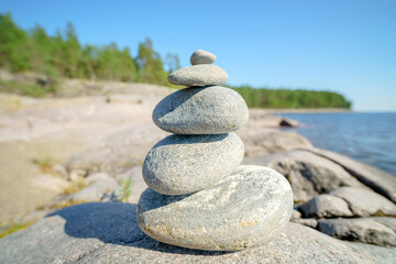 Pyramid of stones. Unstable balance of stone objects. Idyllic state of nature.