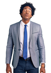 Handsome african american man with afro hair wearing business jacket looking at the camera blowing a kiss on air being lovely and sexy. love expression.