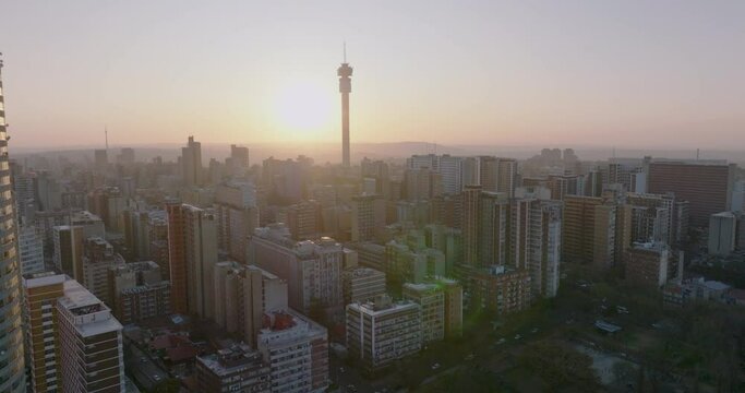 Aerial view of the magnificent Johannesburg City Centre at sunset surrounded by smog and pollution