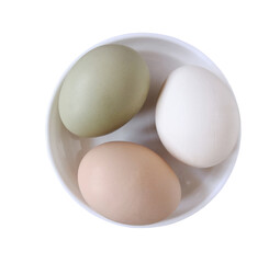 Chicken eggs in a white bowl on a white isolated background