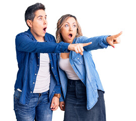 Obraz premium Couple of women wearing casual clothes pointing with finger surprised ahead, open mouth amazed expression, something on the front