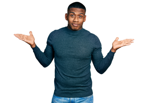 Young black man wearing casual sweater clueless and confused with open arms, no idea and doubtful face.