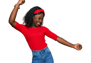 Beautiful african young woman wearing casual clothes dancing happy and cheerful, smiling moving casual and confident listening to music