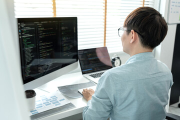 Male programmer is programming to develop program app and website of corporate while working to...