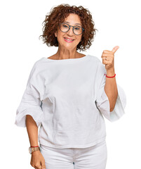 Beautiful middle age mature woman wearing casual clothes and glasses smiling with happy face...