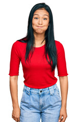 Obraz premium Beautiful hispanic woman wearing casual clothes puffing cheeks with funny face. mouth inflated with air, crazy expression.