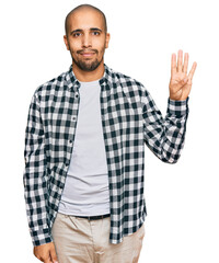 Naklejka premium Hispanic adult man wearing casual clothes showing and pointing up with fingers number four while smiling confident and happy.