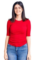 Young beautiful girl wearing casual t shirt looking positive and happy standing and smiling with a confident smile showing teeth