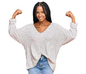 Beautiful hispanic woman wearing casual clothes showing arms muscles smiling proud. fitness concept.