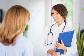 Female doctor consulting with her patient at doctor's office