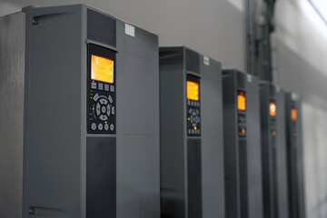 Row of industrial powerful electric inverters used for electric motors
