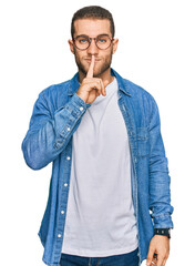 Young caucasian man wearing casual clothes asking to be quiet with finger on lips. silence and...