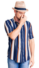 Young handsome caucasian man wearing summer hat tired rubbing nose and eyes feeling fatigue and headache. stress and frustration concept.