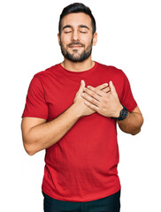Young hispanic man wearing casual clothes smiling with hands on chest with closed eyes and grateful...
