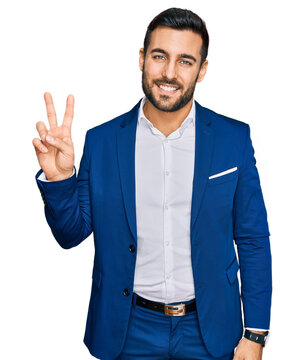 Young hispanic man wearing business jacket smiling looking to the camera showing fingers doing victory sign. number two.