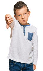 Adorable caucasian kid wearing casual clothes looking unhappy and angry showing rejection and negative with thumbs down gesture. bad expression.