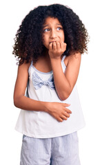 Fototapeta na wymiar African american child with curly hair wearing casual clothes looking stressed and nervous with hands on mouth biting nails. anxiety problem.
