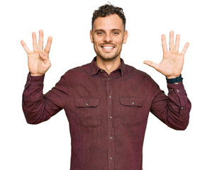Fototapeta premium Young hispanic man wearing casual clothes showing and pointing up with fingers number nine while smiling confident and happy.