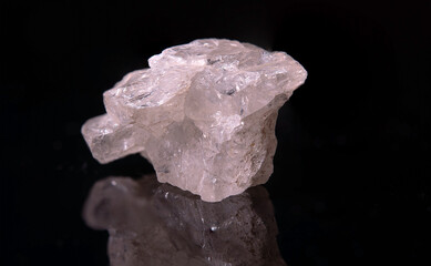 A fragment of a pinkish beryl crystal with small black inclusions