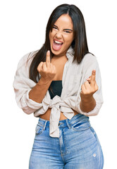 Young beautiful hispanic girl wearing casual clothes showing middle finger doing fuck you bad...
