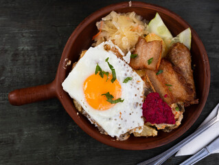 Breakfast dish - scrambled eggs with fried bacon